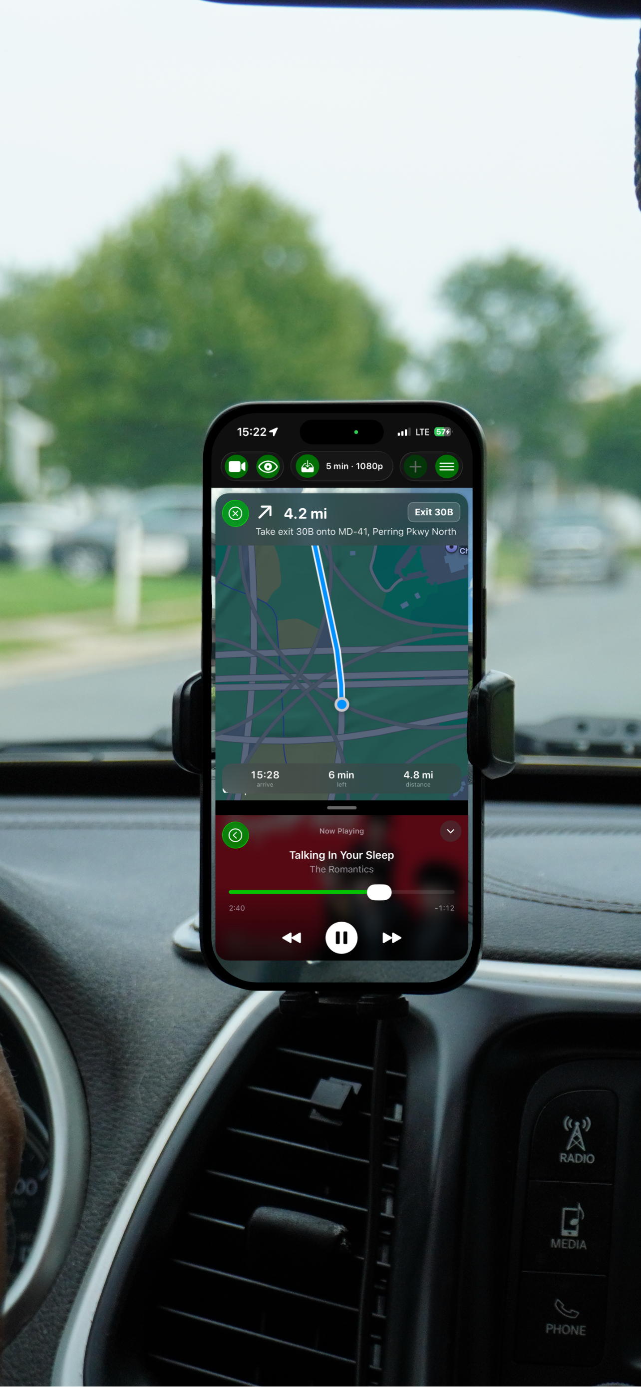 GoDash showing turn-by-turn navigation above a compact now-playing music bar