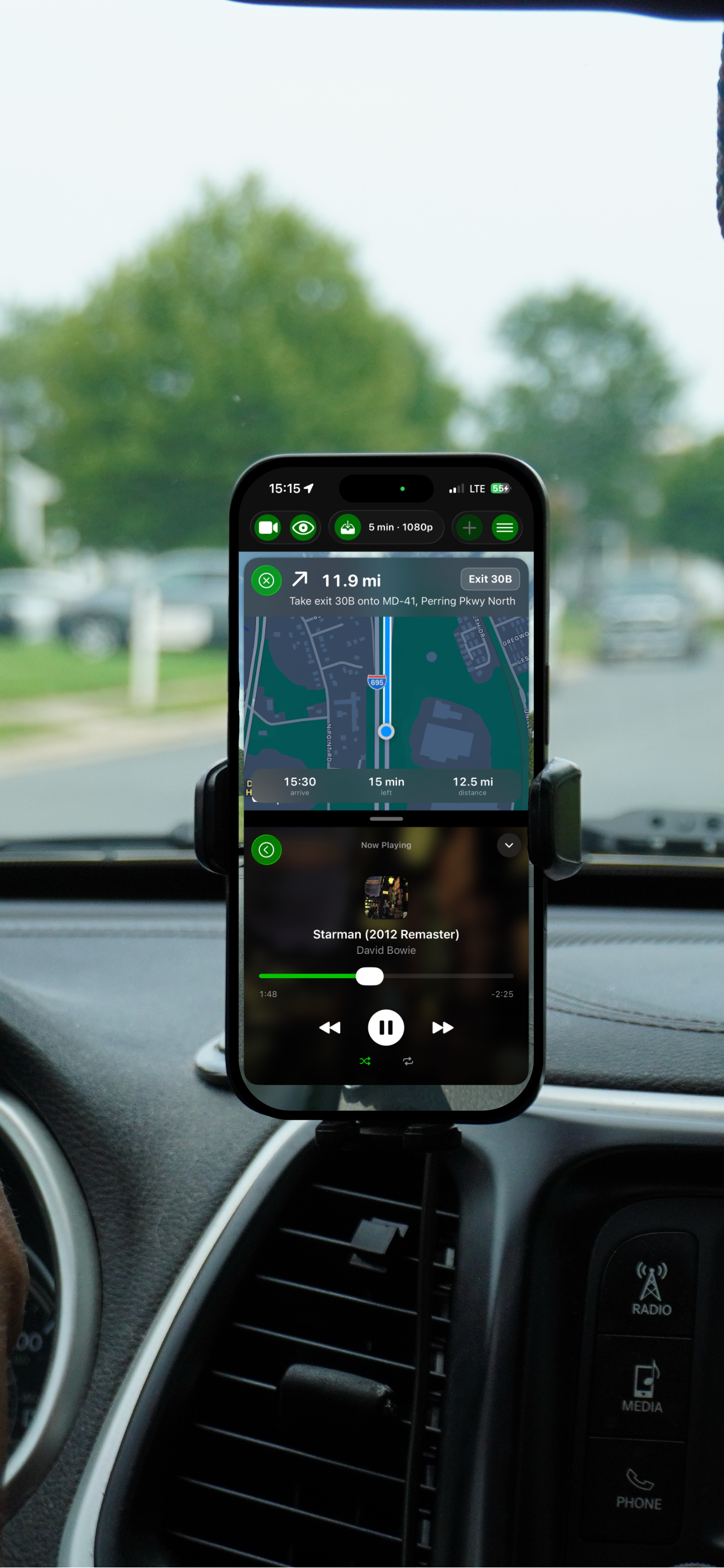 GoDash in a car mount showing turn-by-turn navigation above the Now Playing music player